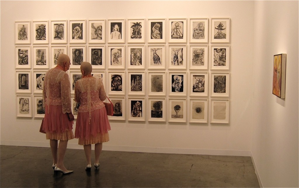 Art lovers at a gallery during Art Basel in Miami in Towleroad and ManAboutWorld gay travel magazine