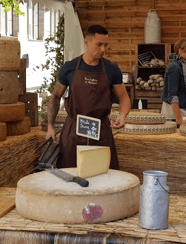 Handsome cheesemonger in port. Uniworld cruise on Towleroad and in ManAboutWorld gay travel magazine