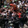 Israeli police beat mourners at funeral of slain Palestinian journalist